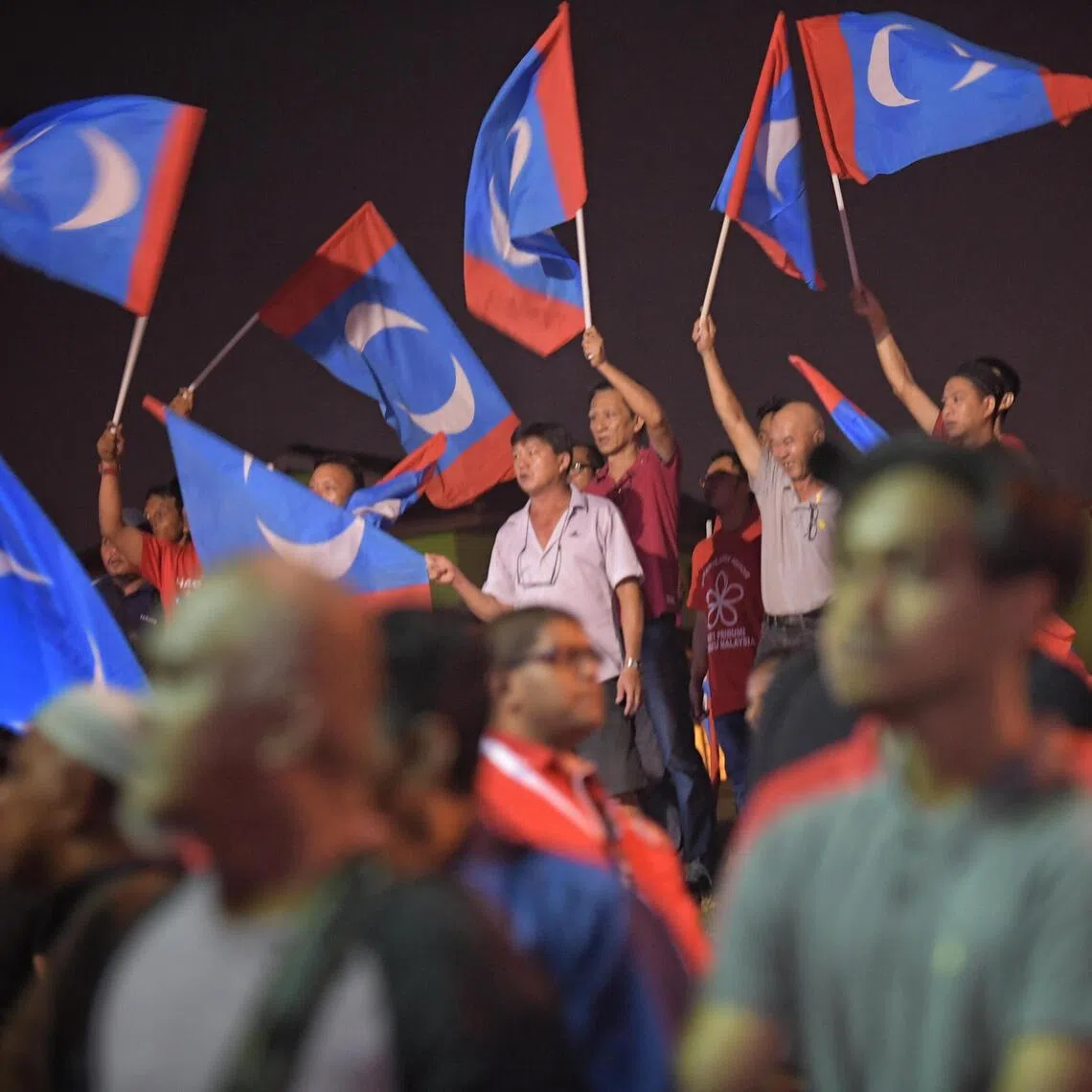 Supporters waving the PKR flag at an election rally. Petaling Jaya MP Lee Chean Chung has resigned after his membership was suspended for three years.