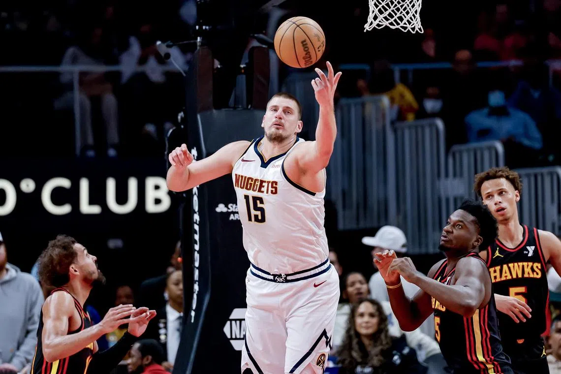 Denver Nuggets centre Nikola Jokic making an offensive rebound against Atlanta Hawks guard Trae Young (left) en route to helping his side defeat the Hawks 141-111 in a National Basketball Association clash on Dec 8.