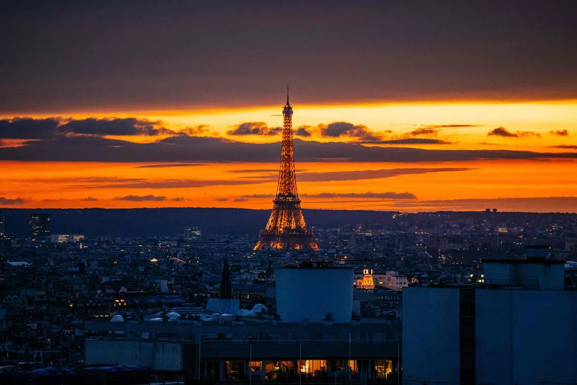 Eiffel Tower being illuminated at sunset on Feb 27. 
