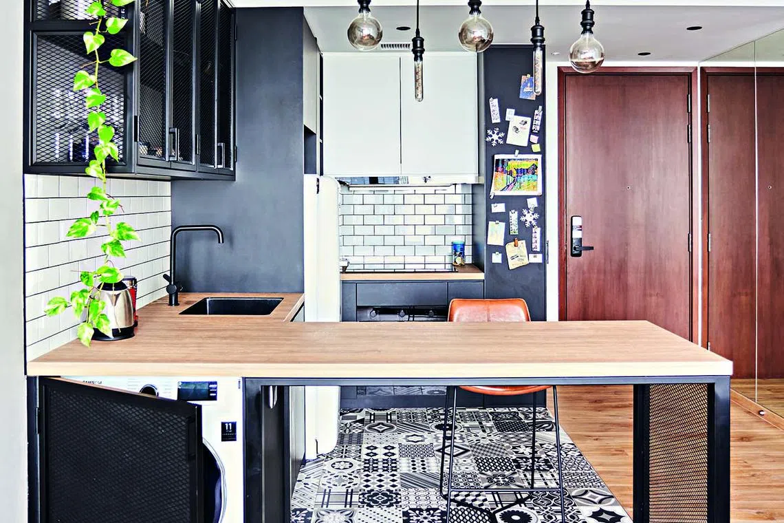 The base of the custom kitchen counter hides a washer and dryer. 