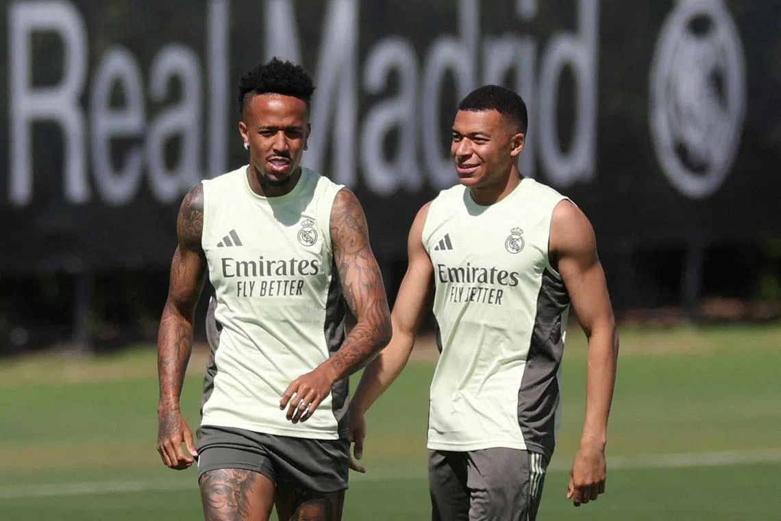 FILE PHOTO: Soccer Football - Club World Cup - Real Madrid Training - Gardens North Country District Park, Palm Beach Gardens, Florida, U.S. - June 15, 2025 Real Madrid's Eder Militao and Kylian Mbappe during training REUTERS/Hannah Mckay/File Photo