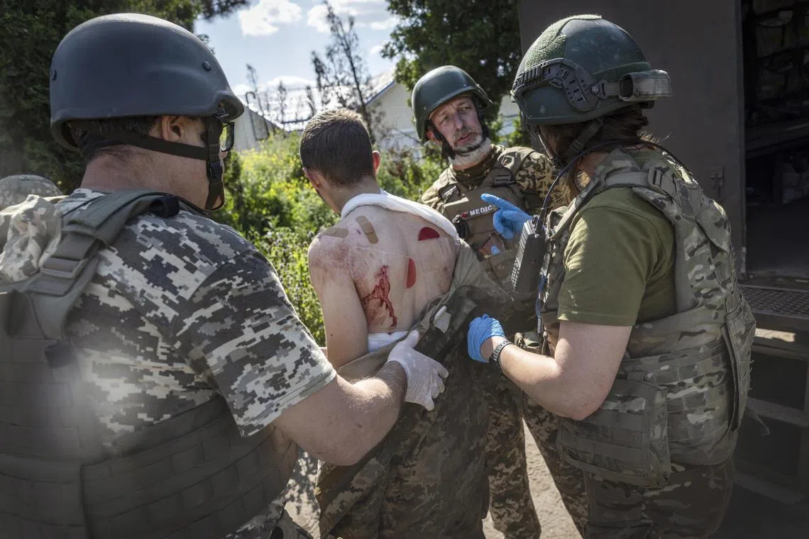 Ukrainian medics with the 72nd Brigade evacuate an injured soldier from the front line, in the Donetsk region of Ukraine.