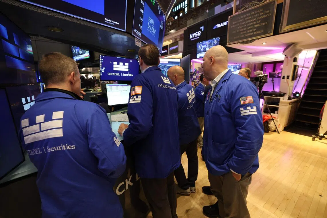 Traders work on the floor of the New York Stock Exchange at the opening bell on Oct 5 in New York City.