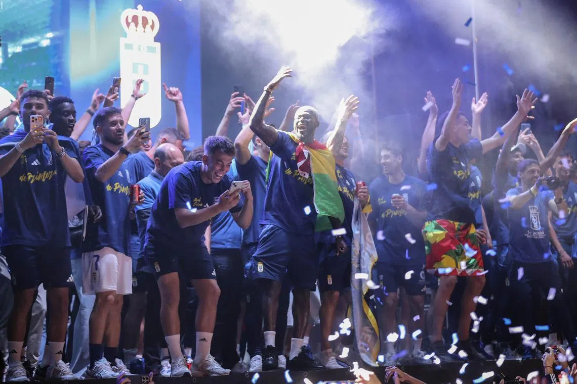 Real Oviedo's players celebrate their return to the Spanish La Liga after winning the home second leg of the promotion play-off against Mirandes on June 22, 2025.