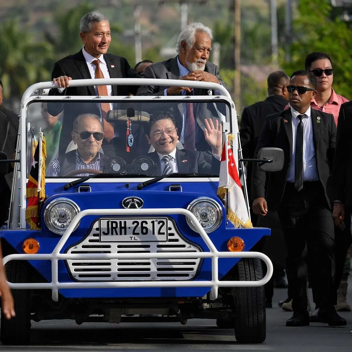 Timor Leste school children line the streets leading to the delegation hotel as Singapore Prime Minister Lawrence Wong (centre) rides on a mini moke driven by Timor Leste president Jos Ramos-Horta from the airport, with Singapore Foreign Minister Vivian Balakrishnan and Timor Leste Prime Minister Xanana Gusmao, on July 2, 2026.