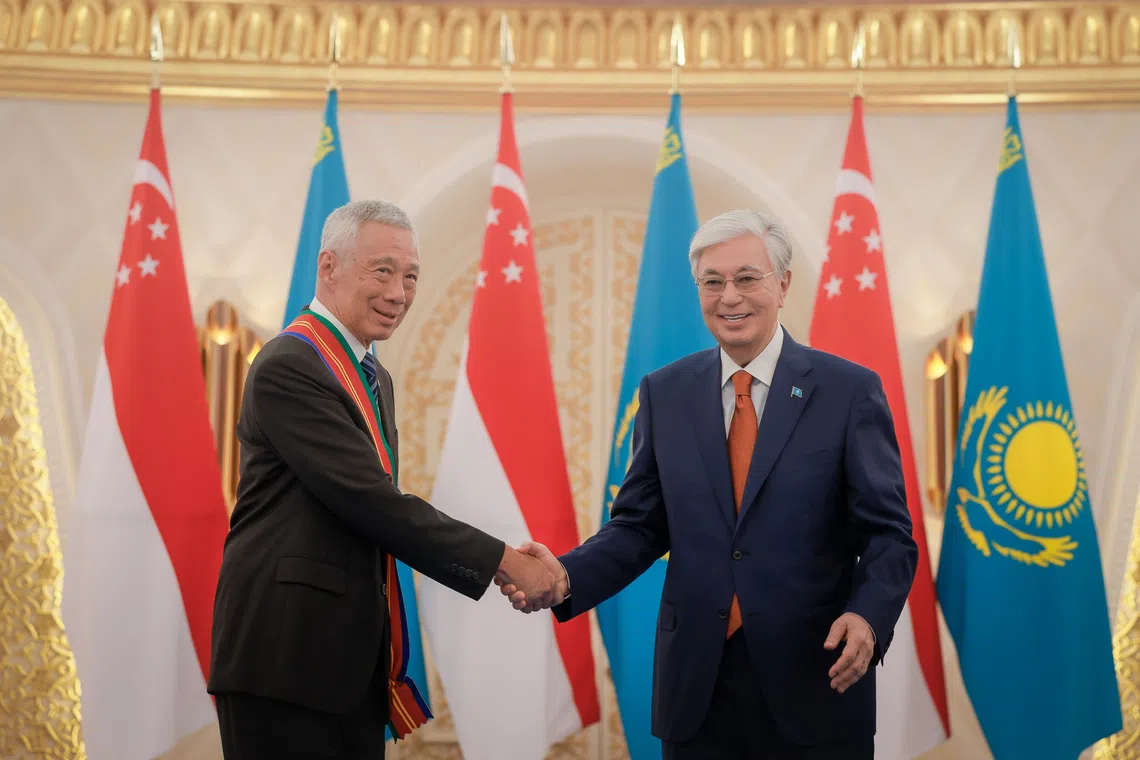 Senior Minister Lee Hsien Loong (left) is conferred the Order of Dostyk, First Class, by Kazakhstan President Kassym-Jomart Tokayev at Akorda Presidential Palace in Astana on Aug 26.