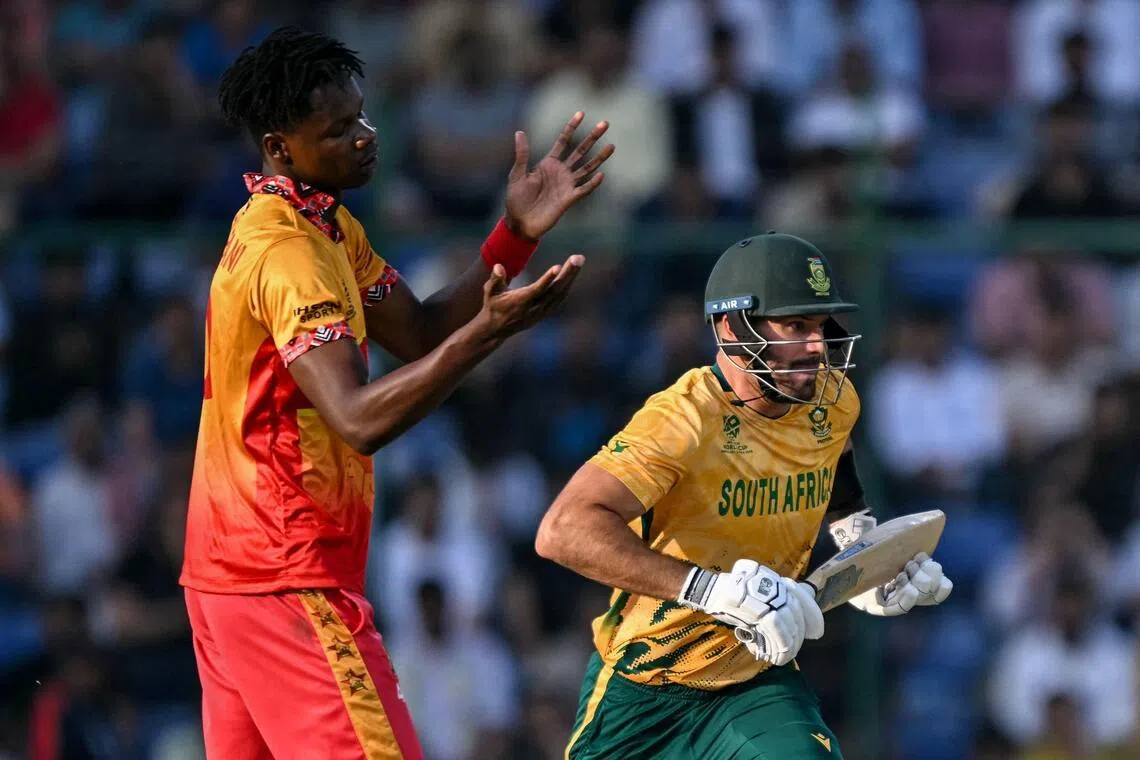 South Africa's captain Aiden Markram runs between the wickets as Zimbabwe's Blessing Muzarabani reacts in their ICC Men's T20 Cricket World Cup Super Eights match at the Arun Jaitley Stadium in New Delhi on March 1, 2026.