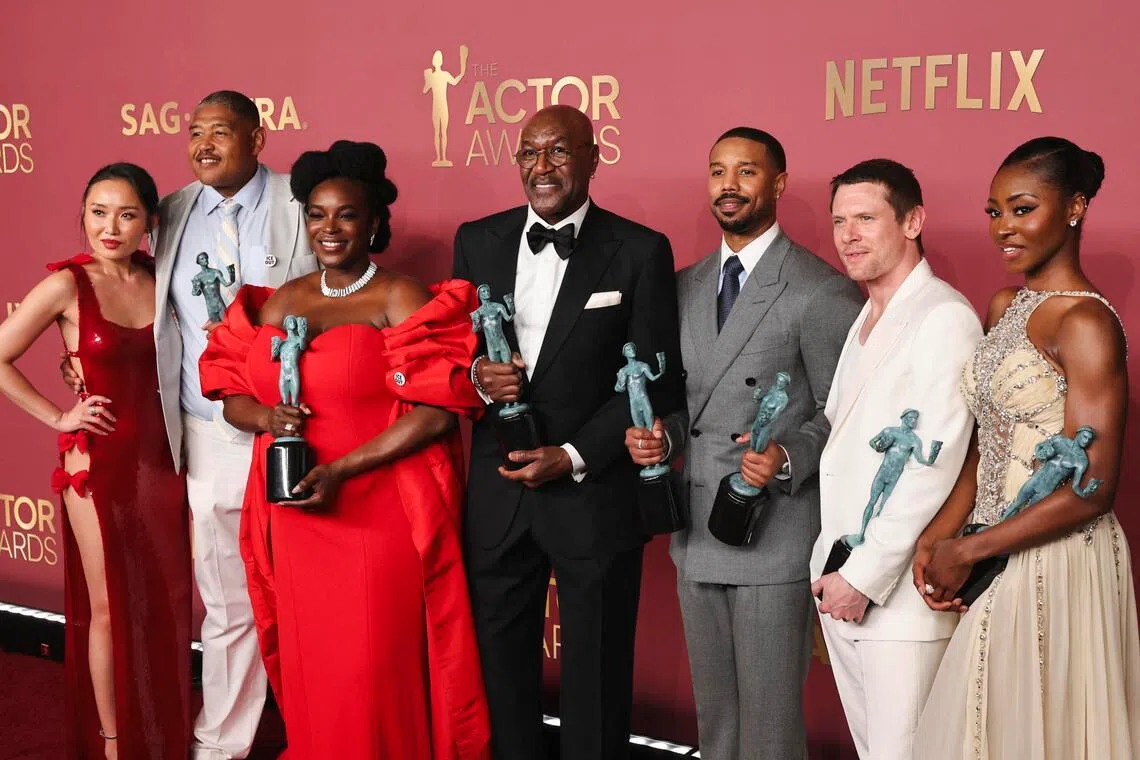 (From left) Actor Li Jun Li, Omar Benson Miller, Wunmi Mosaku, Delroy Lindo, Michael B Jordan, Jack O'Connell and Jayme Lawson with the Outstanding Performance By A Cast In A Motion Picture award for Sinners during the Actor Awards on March 1. 