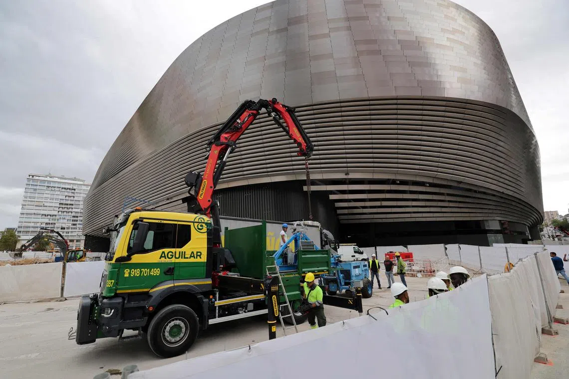 Workers with their construction machineries in front of Real Madrid's Santiago Bernabeu stadium.