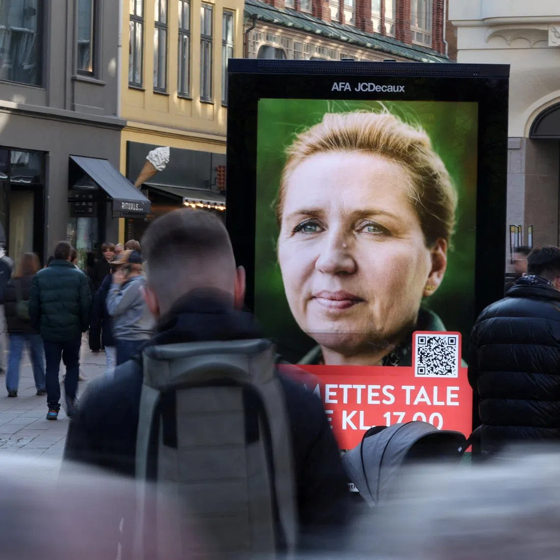 People pass an election advertisement for Mette Frederiksen, Denmark's Prime Minister and leader of the Social Democrats party ahaed of parliamentary elections in Copenhagen, Denmark, March 22, 2026. REUTERS/Leonhard Foeger