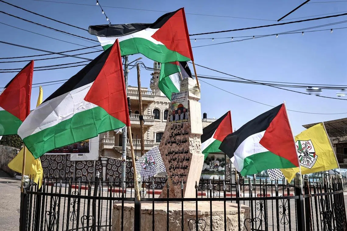 Palestinian flags The Martyrs Monument which bears the names of those killed by the Israeli army or Jewish settlers in Abu Falah. 