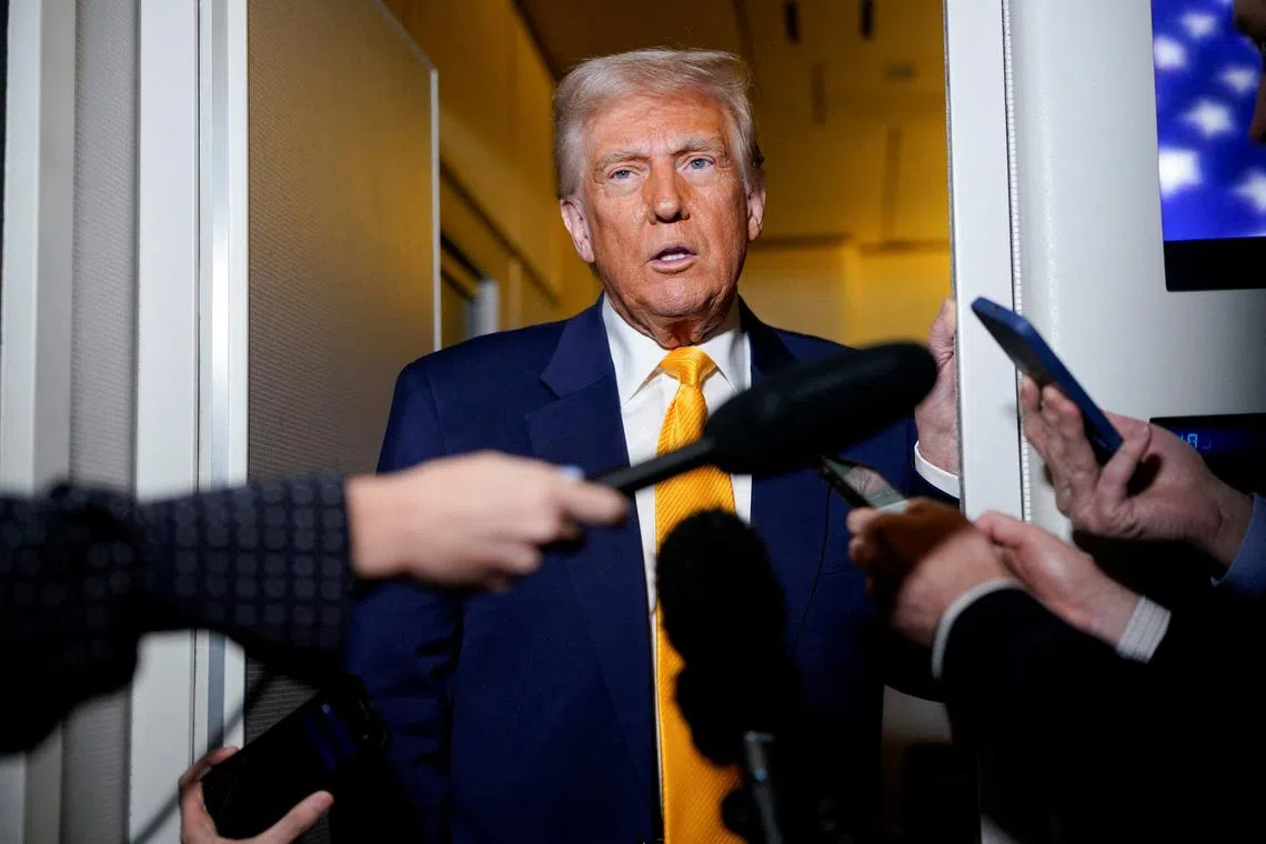 FILE PHOTO: U.S. President Donald Trump speaks to the media on board Air Force One on the way to Miami, Florida, U.S., April 12, 2025. REUTERS/Nathan Howard/File Photo