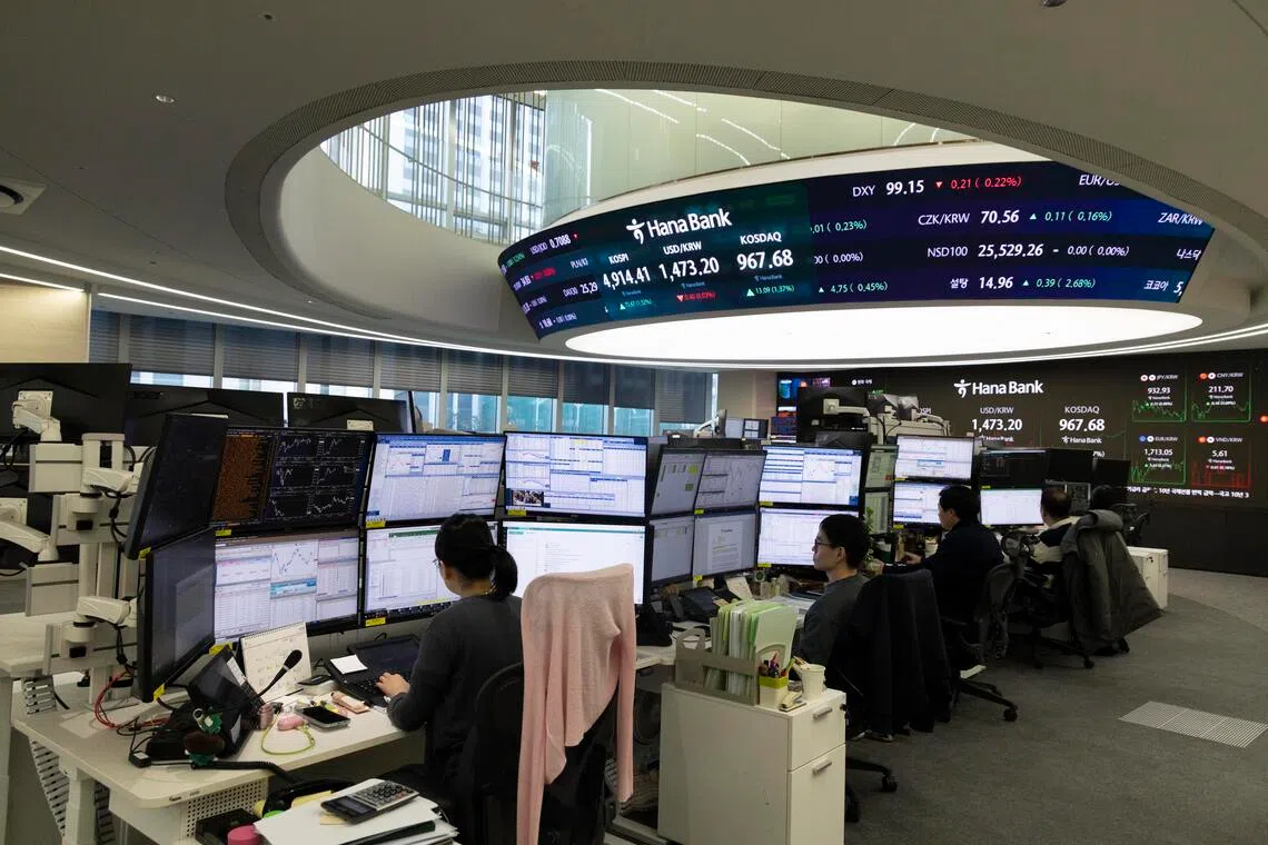 Traders work at Hana Bank in Seoul, South Korea, on Jan 19, 2026.