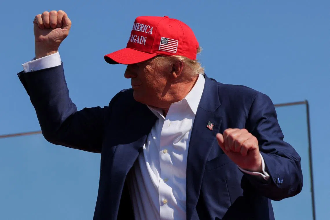 FILE PHOTO: Republican presidential nominee and former U.S. President Donald Trump gestures at a campaign rally in Wilmington, North Carolina, U.S., September 21, 2024. REUTERS/Brian Snyder/File Photo