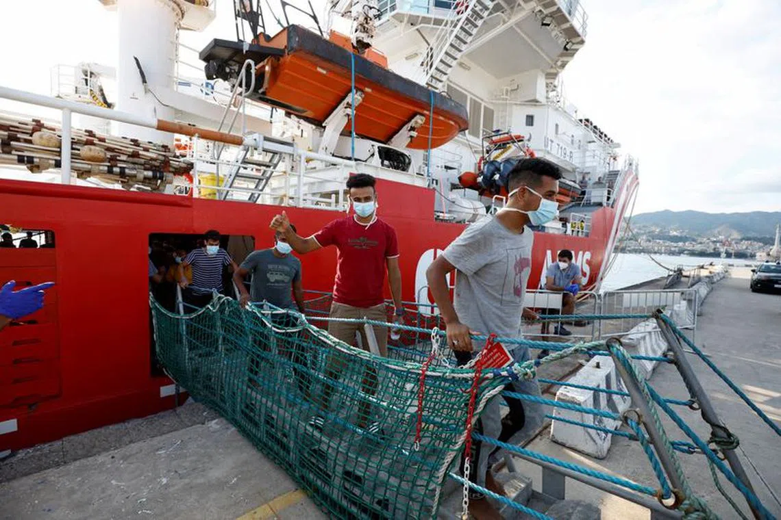 FILE PHOTO: Migrants disembark from Open Arms rescue boat after arriving at Messina port, Sicily, Italy August 27, 2022. REUTERS/Juan Medina/File Photo
