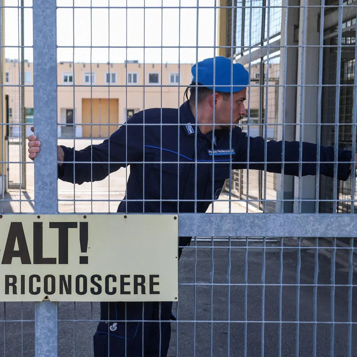 A penitentiary police officer closing a gate of Sant’Anna prison in Modena, Italy, on May 19.