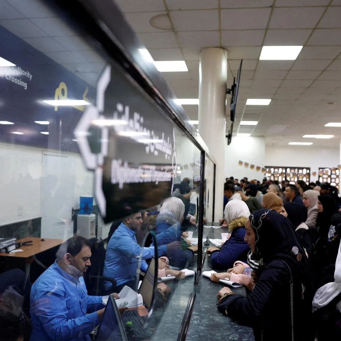 Syrians living in Lebanon wait at the Ministry of Interior Immigration and Passports Department, at the Syrian-Lebanese border, as they return to Syria due to ongoing hostilities between Hezbollah and Israeli forces, amid the U.S.-Israeli conflict with Iran, in Jdaydet Yabous, Syria, March 3, 2026. REUTERS/Yamam Al Shaar