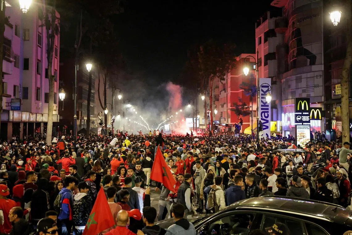 Moroccans in Rabat celebrate their team's historic victory over Spain which allowed them to reach the quarter-finals of the World Cup. 