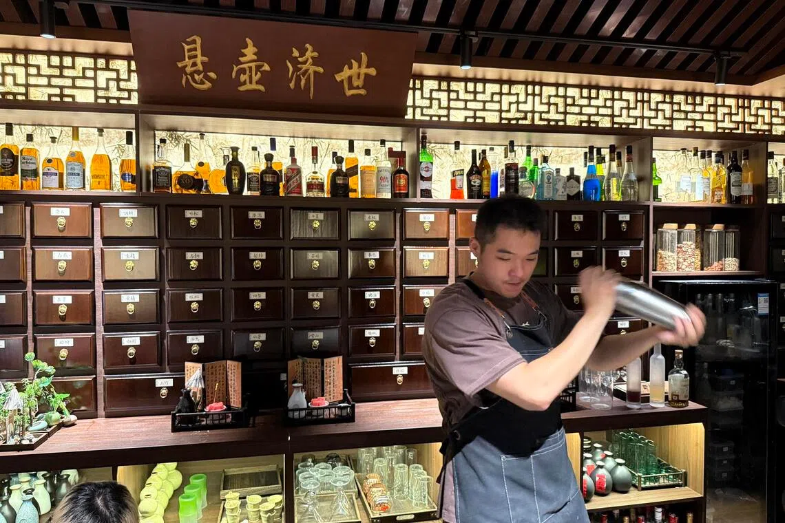 jytcm - A bartender shakes up a herbal cocktail at Niang Qing, a TCM-themed bar in Shanghai.

ST PHOTO: JOYCE ZK LIM