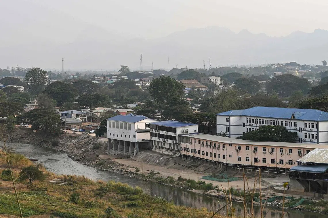 (FILES) A general view of Myanmar's Myawaddy town is seen from across the Thai side in Mae Sot district on April 11, 2024. Thirty nine foreigners have fled an online scam centre in Myanmar across the border to Thailand, where officials are working to identify potential trafficking victims, police told AFP on November 25, 2024. (Photo by MANAN VATSYAYANA / AFP)