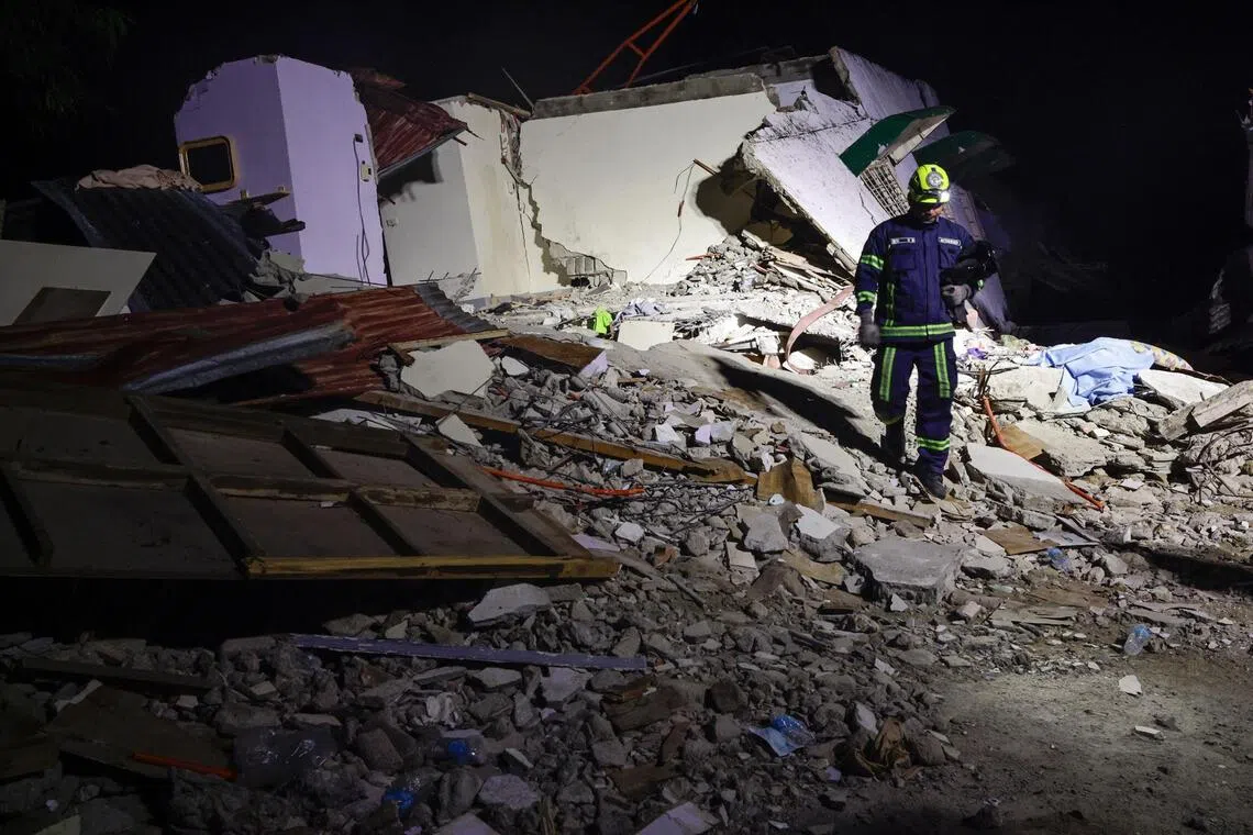 A Philippine emergency response personnel walks off from the site of an earthquake-damaged, collapsed facility in Bogo City, Cebu, Philippines, on Oct 1, 2025.