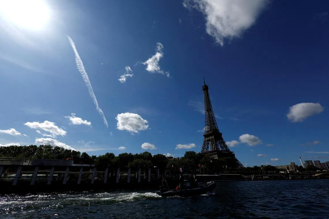 FILE PHOTO: Paris 2024 Olympics - Technical test on the Seine river - Paris, France - July 17, 2023 The Eiffel Tower is seen in the background as Paris hold a technical test for boats as part of preparations for the river parade on the Seine for the opening ceremony of the Paris 2024 Olympic games. REUTERS/Gonzalo Fuentes/File Photo