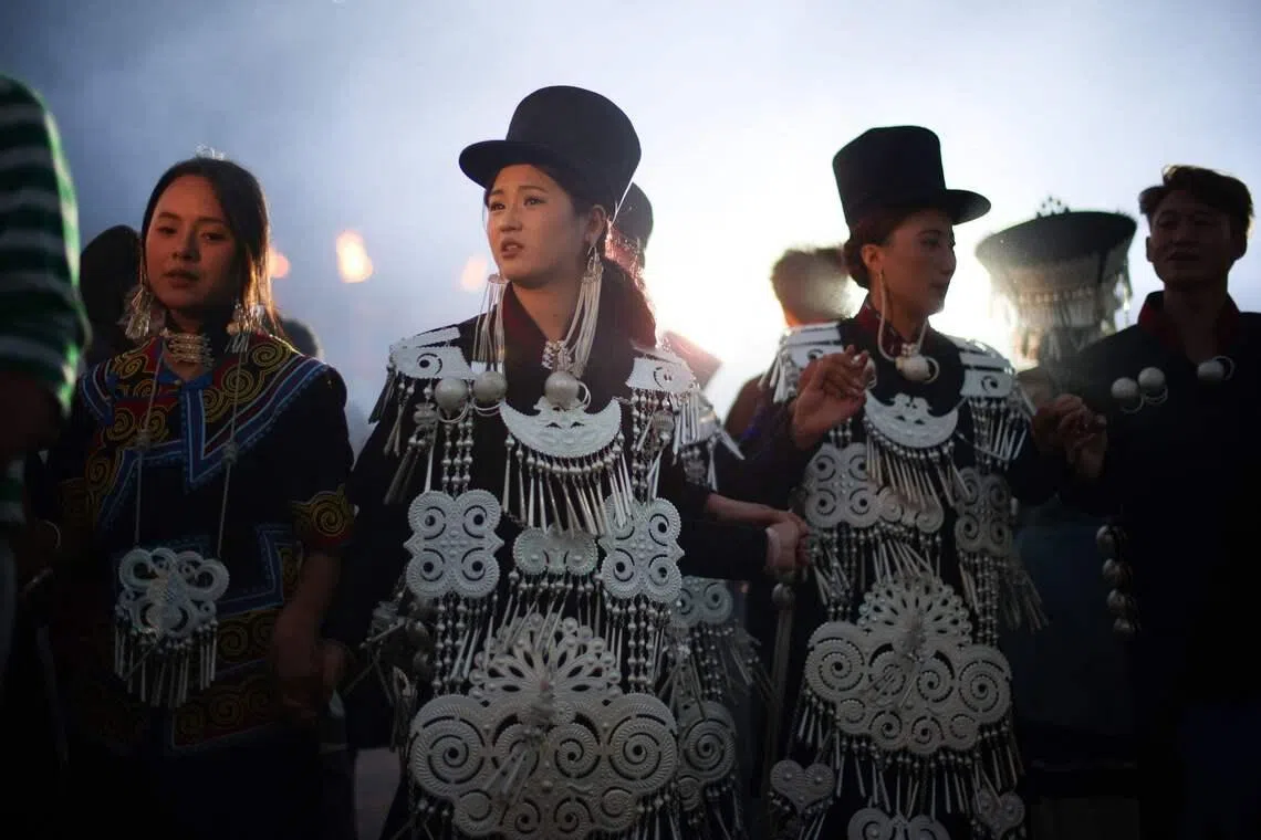People walk hand in hand as they celebrate the Torch Festival, held by the Yi ethnic minority, in Puge County, Liangshan Prefecture, in Chinas southwest Sichuan Province on July 19, 2026. The celebrations took in traditional folk activities such as horse racing, bullfighting, and dancing and singing around bonfires. (Photo by CN-STR / AFP) / China OUT