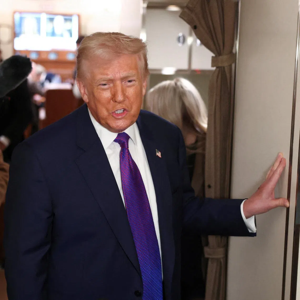 U.S. President Donald Trump speaks to reporters aboard Air Force One, February 19, 2026. REUTERS/Kevin Lamarque