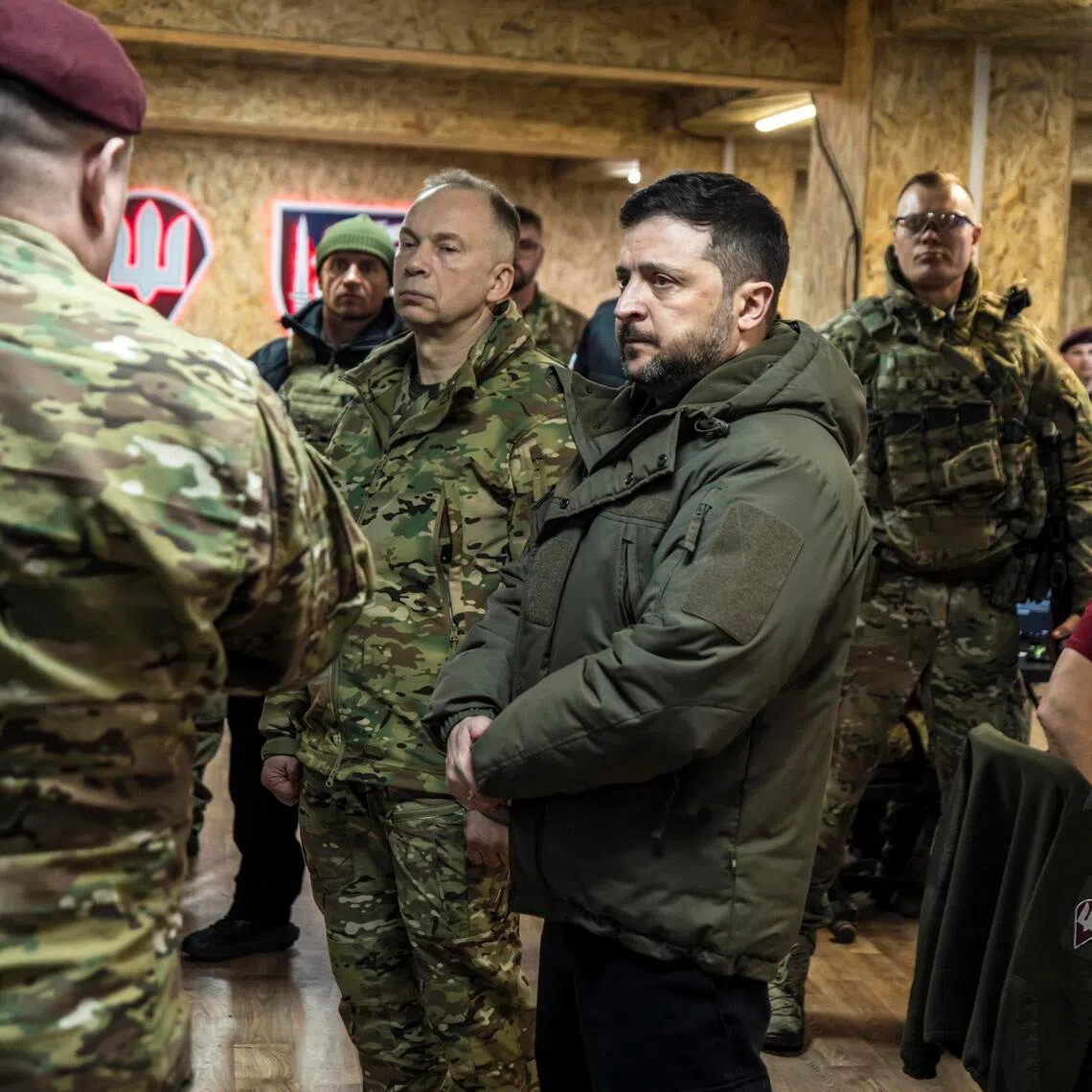 Ukrainian President Volodymyr Zelensky (centre right) and General Oleksandr Syrskyi (centre left) visiting a command post in Ukraine's eastern Donbas region in March 2026.