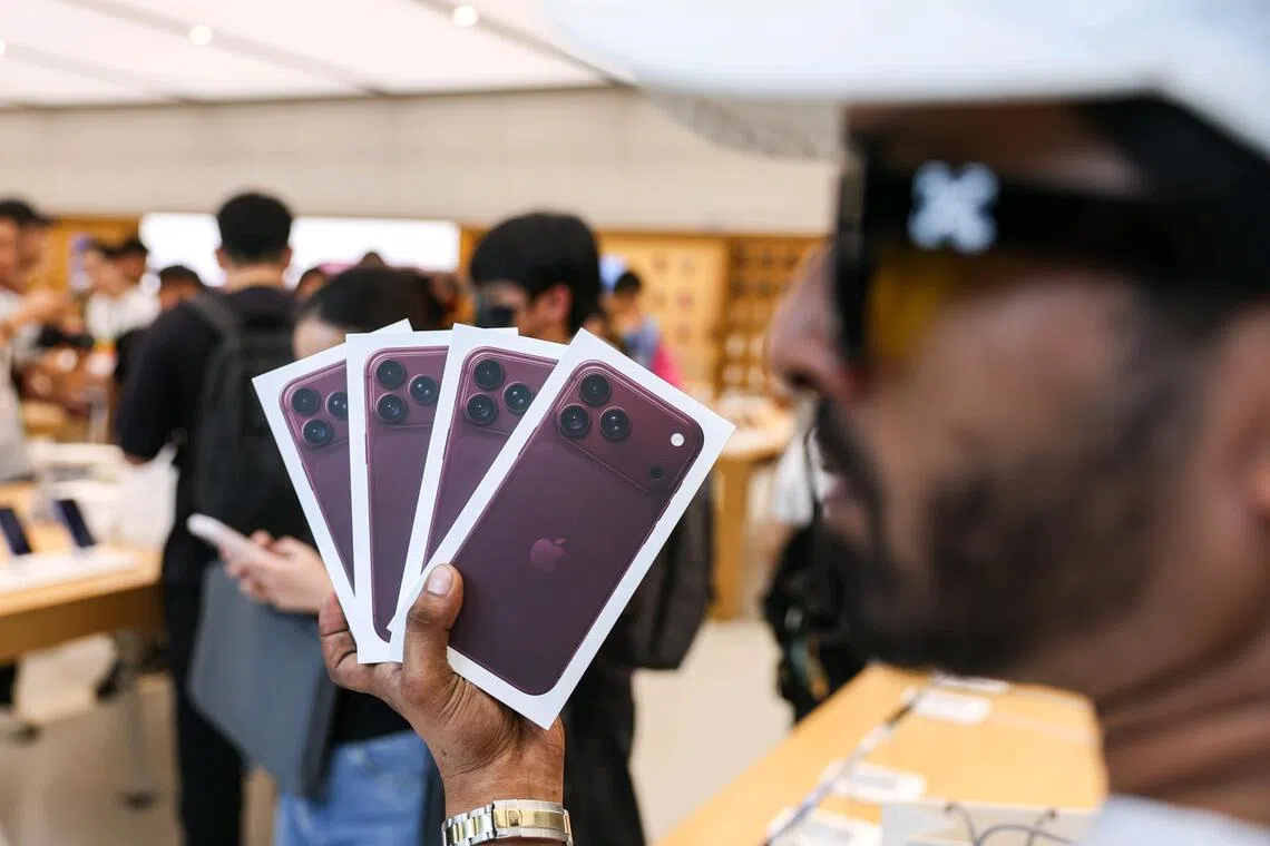 Tourists posing with their new iPhone 18 Pro phones during its launch at the Apple Store on Sept 18.