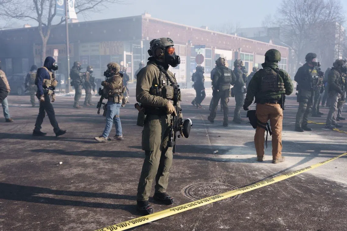 Federal agents stand amid teargas near the site where a man identified as Alex Pretti was fatally shot by federal agents trying to detain him, in Minneapolis, Minnesota, U.S., January 24, 2026.REUTERS/Tim Evans