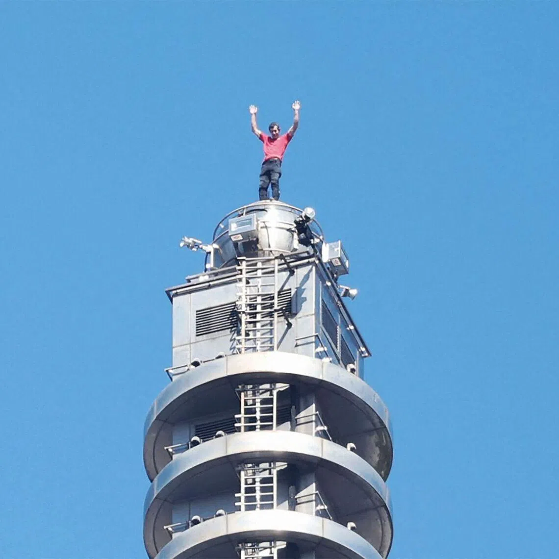 Alex Honnold celebrates after completing his free-solo climb of Taipei 101.