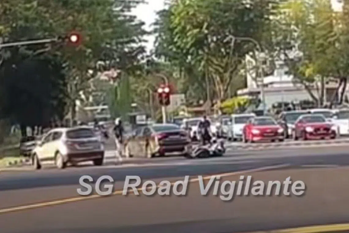 A motorcycle going straight on Commonwealth Avenue West is seen colliding with a car making a right turn onto Clementi Avenue 2. 