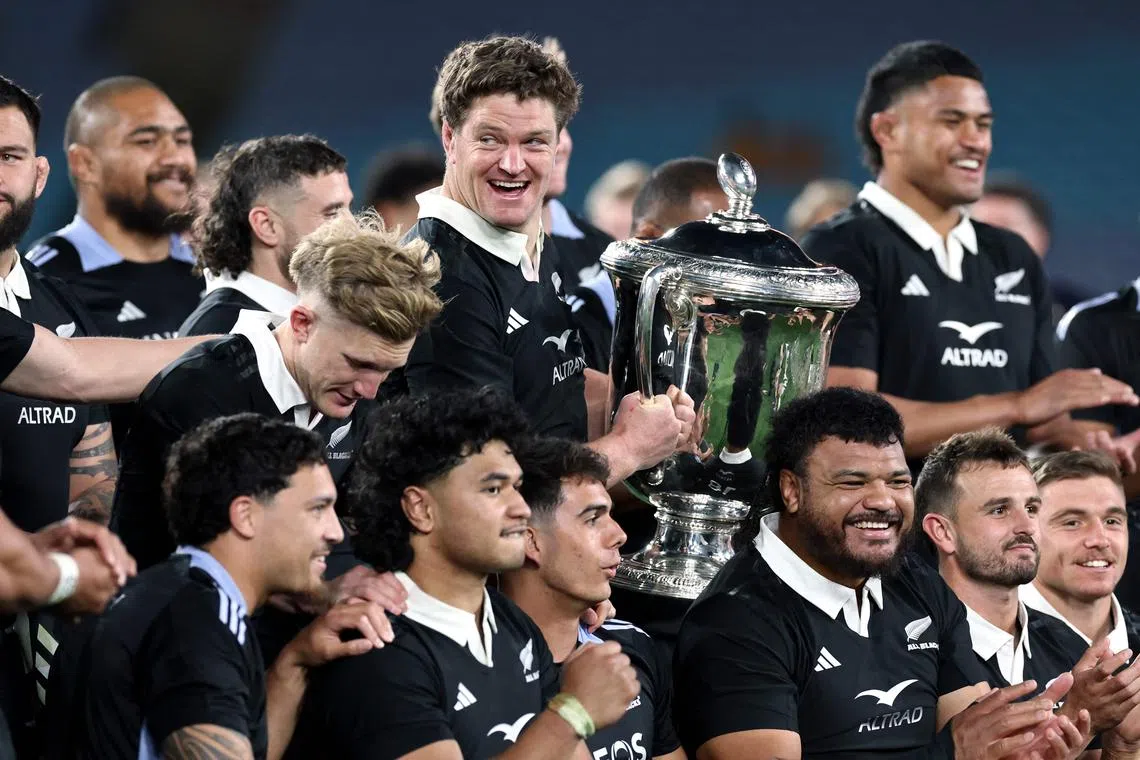 New Zealand captain Scott Barrett holds the Bledisloe Cup trophy after winning against Australia.