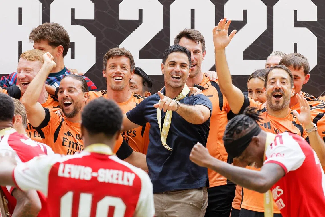 Arsenal manager Mikel Arteta (centre) celebrating with players and staff after beating Manchester City 3-0, at the Millennium Stadium in Cardiff on Aug 16.