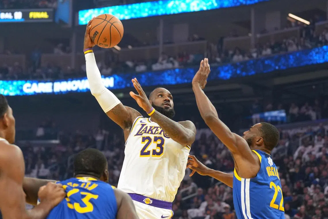 Los Angeles Lakers forward LeBron James (23) shooting against Golden State Warriors forward Andrew Wiggins (22) during the first quarter at Chase Centre on Dec 25.