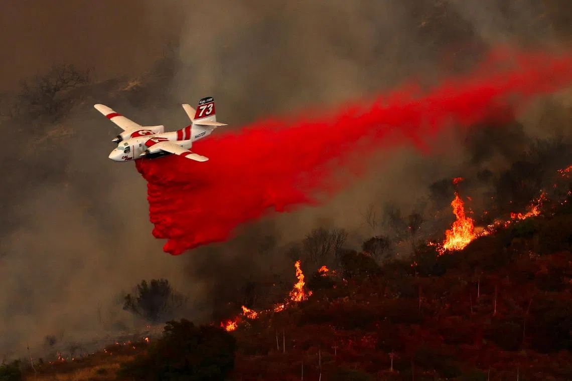 An aerial tanker combating a wildfire burning in the hills of Orange County, California, U.S., Sep 9, 2024.  