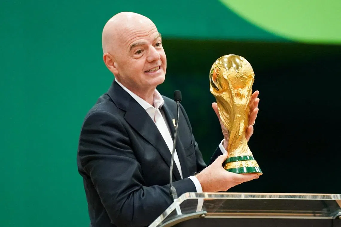 Jun 1, 2026; Dallas, Texas, USA; FIFA President Gianni Infantino holds the World Cup trophy while he speaks during the grand opening of the 2026 FIFA World Cup international broadcast center at Kay Bailey Hutchison Convention Center. Mandatory Credit: Raymond Carlin III-Imagn Images