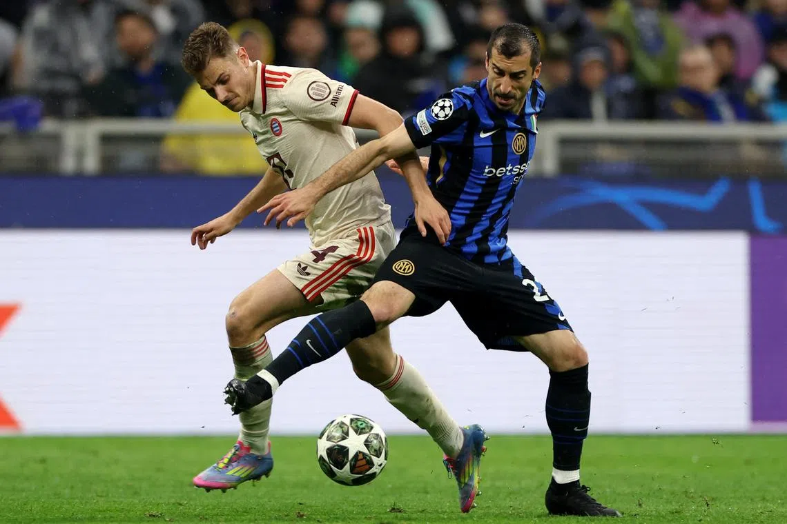 Soccer Football - Champions League - Quarter Final - Second Leg - Inter Milan v Bayern Munich - San Siro, Milan, Italy - April 16, 2025 Bayern Munich's Josip Stanisic in action with Inter Milan's Henrikh Mkhitaryan REUTERS/Claudia Greco