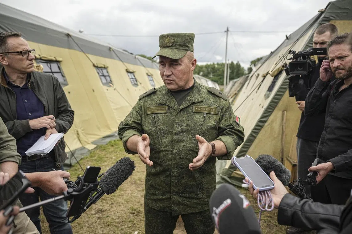 Belarusian Major-General Leonid Kasinsky speaks with international journalists, as they visit a camp meant to accommodate Wagner fighters from Russia.