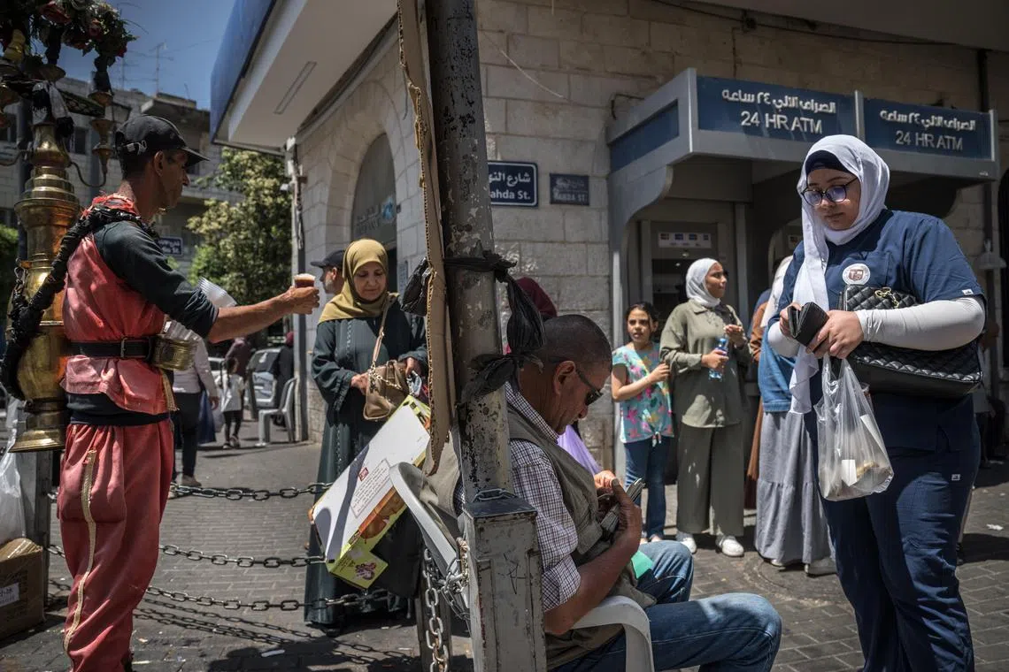 FILE Ñ Outside a bank in Ramallah, in the Israeli-occupied West Bank near Jerusalem, June 10, 2024. IsraelÕs finance minister has reportedly agreed in principle to release funds to the Palestinian Authority in exchange for strengthening Israeli settlements in the territory. (Sergey Ponomarev/The New York Times)