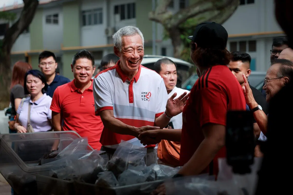 Senior Minister Lee Hsien Loong with residents after the launch of the Ang Mo Kio town council master plan on March 15.