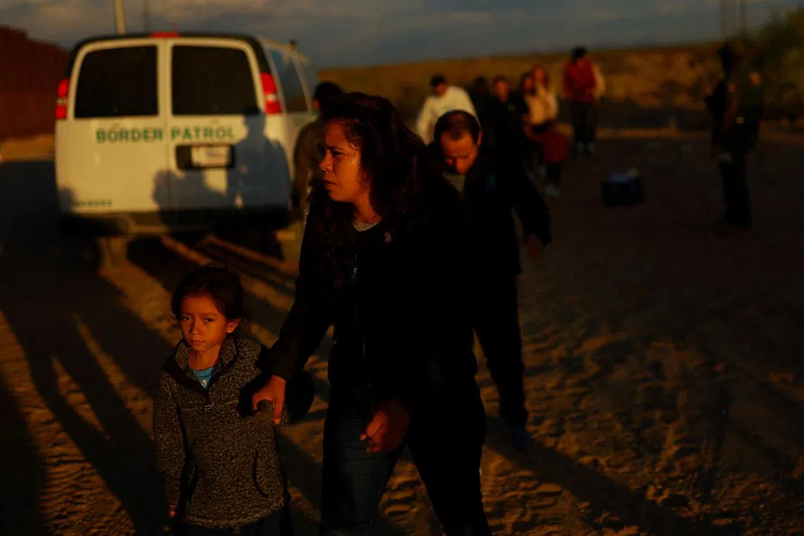 FILE PHOTO: Migrants are detained by U.S. Border Patrol agents after crossing into the United States from Mexico, in Sunland Park, New Mexico, U.S. August 2, 2024. REUTERS/Jose Luis Gonzalez/File Photo