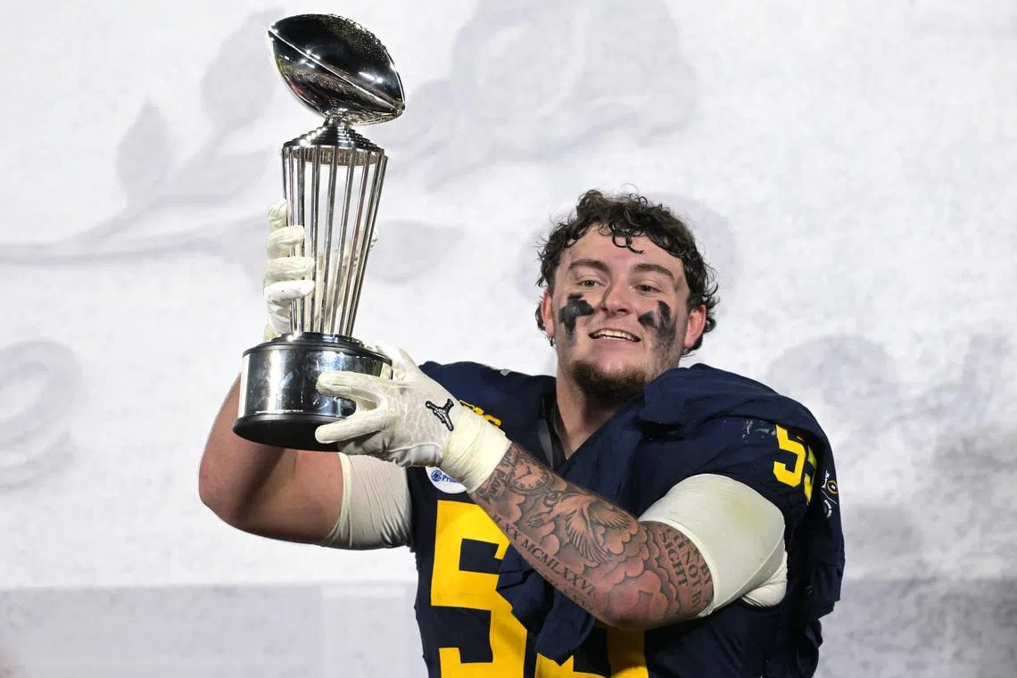Jan 1, 2024; Pasadena, CA, USA; Michigan Wolverines defensive lineman Mason Graham (55) celebrates with the Leishman Trophy after defeating the Alabama Crimson Tide in the 2024 Rose Bowl college football playoff semifinal game at Rose Bowl. Mandatory Credit: Jayne Kamin-Oncea-USA TODAY Sports/ File Photo