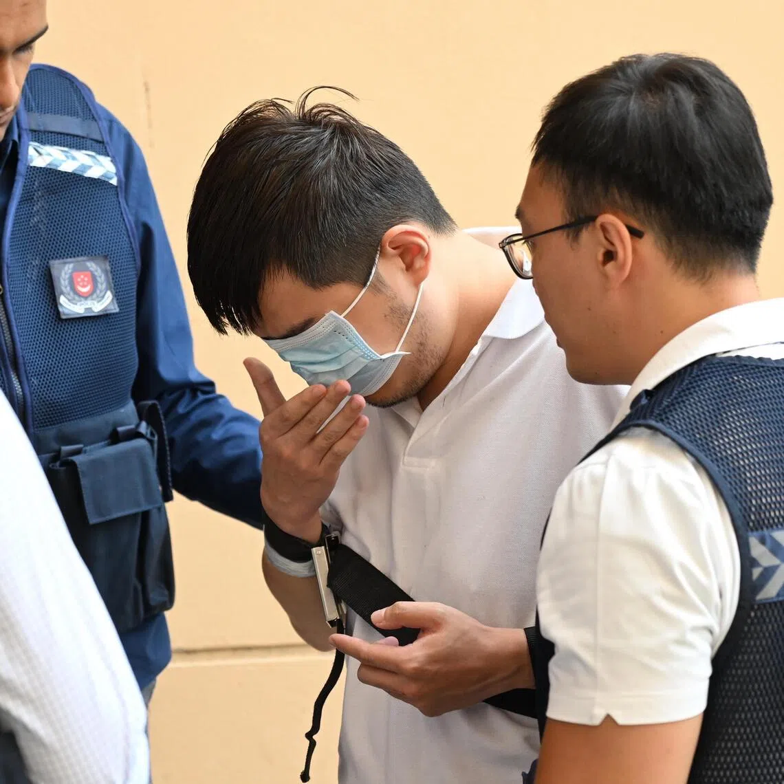 Davin Lian Ke Xiang taken to a crime scene at Blk 296 Punggol Central where he had allegedly thrown eggs at police vehicles.