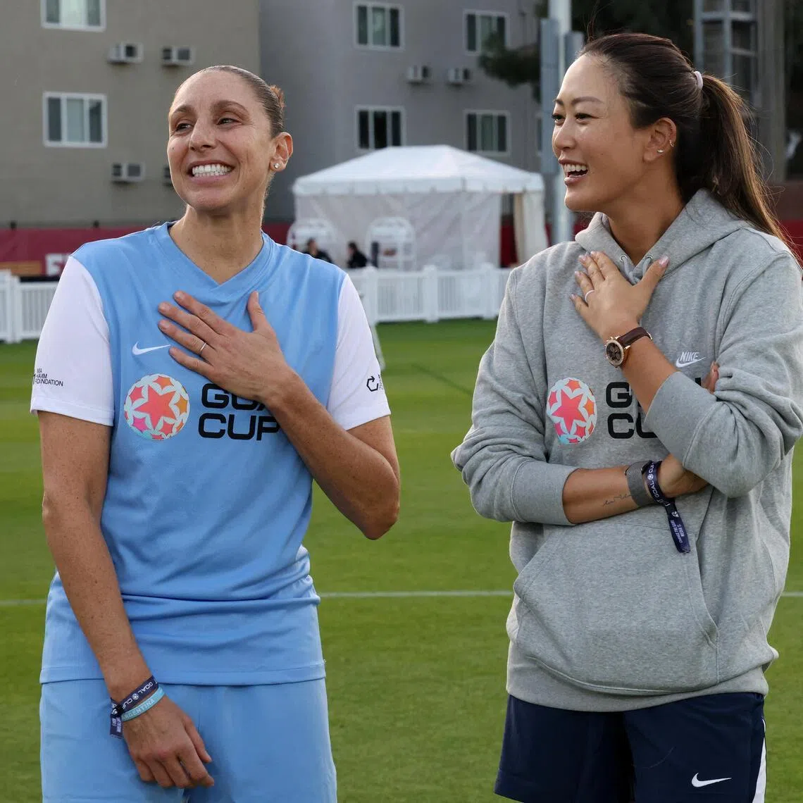 Former basketballer Diana Taurasi (left) and Michelle Wie West on the field before the Goal Cup Celebrity Soccer Match at Rawlinson Stadium on Jan 17.