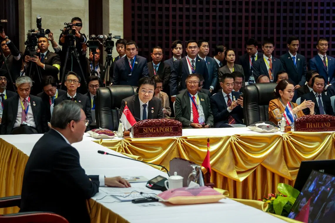 PM Lawrence Wong listening as Chinese Premier Li Qiang speaks during the 27th Asean-China Summit in Vientiane on Oct 10.