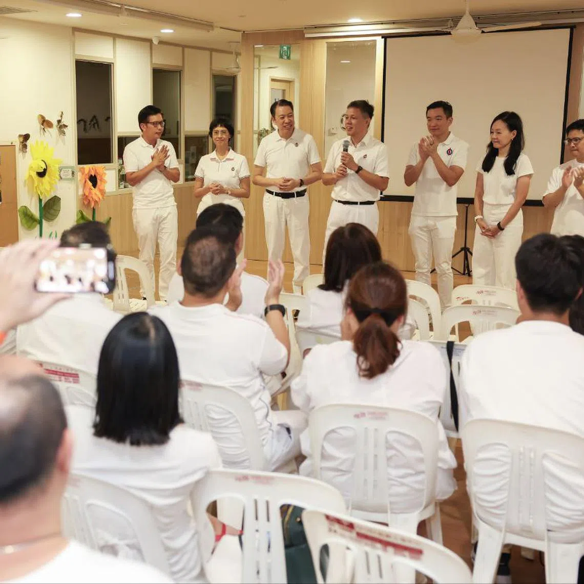 Education Minister Chan Chun Sing (centre) speaking to PAP members on May 3. With him are his fellow Tanjong Pagar GRC candidates (from left) Alvin Tan, Joan Pereira, (from right) Foo Cexiang and Rachel Ong, as well as Radin Mas candidate Melvin Yong (third from left) and Queenstown candidate Eric Chua.