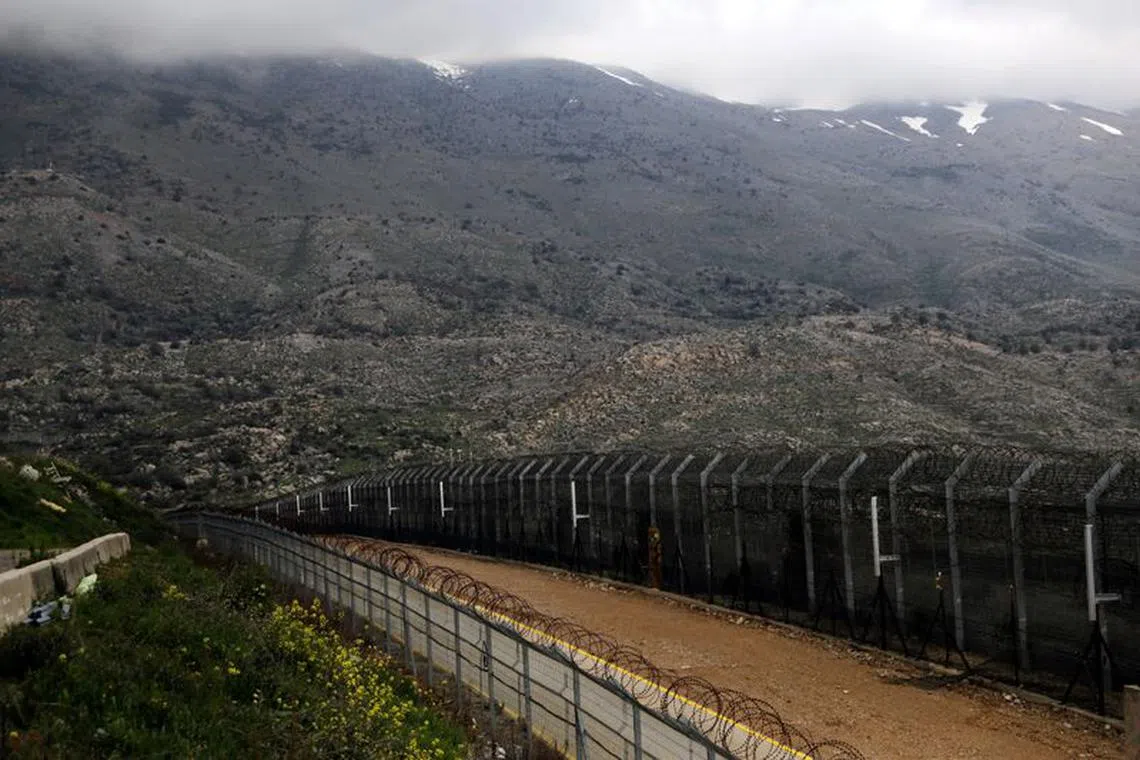 FILE PHOTO: Fences are seen on the ceasefire line between Israel and Syria in the Israeli-occupied Golan Heights, March 25, 2019. REUTERS/Ammar Awad/File Photo