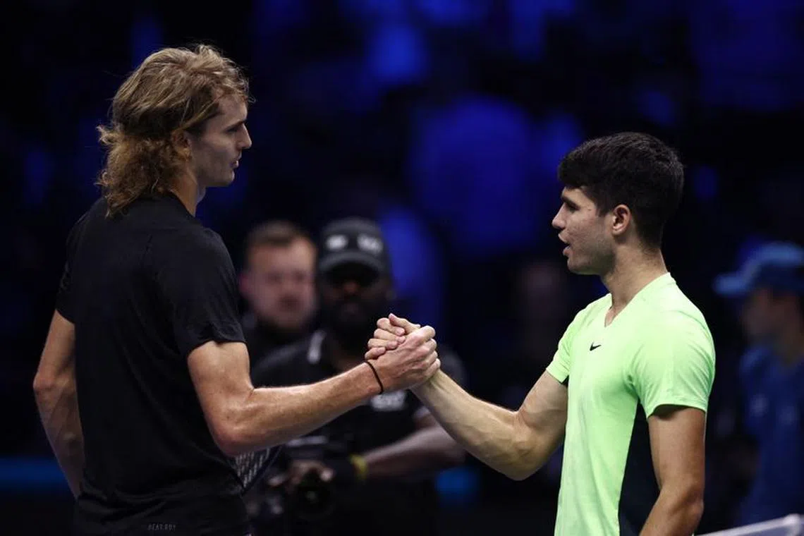 Tennis - ATP Finals - Pala Alpitour, Turin, Italy - November 13, 2023 Germany's Alexander Zverev shakes hands with Spain's Carlos Alcaraz after winning their group stage match REUTERS/Guglielmo Mangiapane